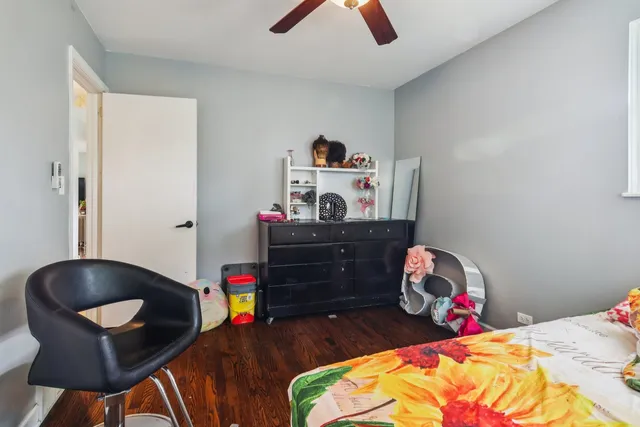 a bed room with a bed a desk and a chandelier