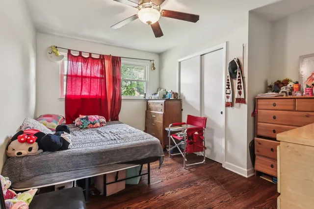 a bedroom with a bed and wooden floor