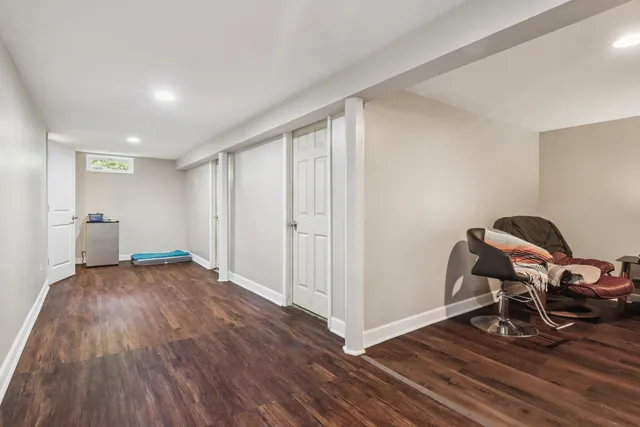 a view of a room with wooden floor and furniture