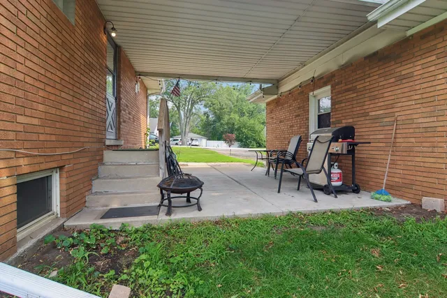 a view of a patio with table and chairs and potted plants