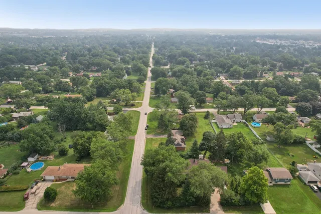 an aerial view of residential houses with city view