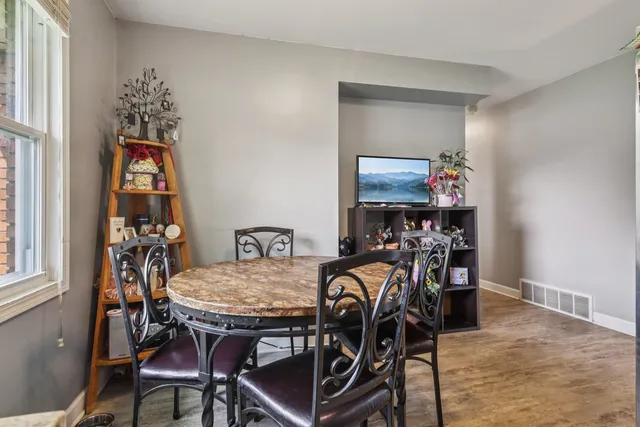 a view of a dining room with furniture and window