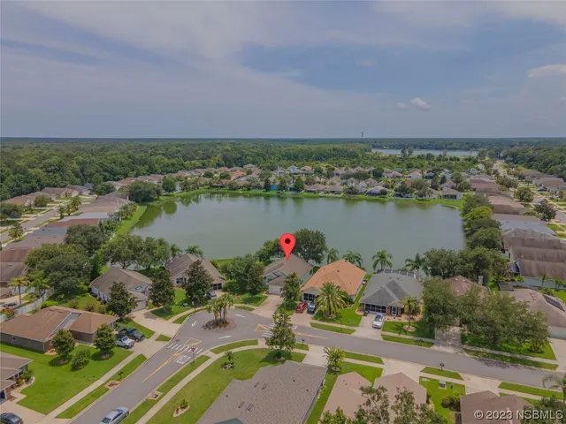 an aerial view of a house with a lake view