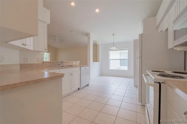 a kitchen with a refrigerator sink and stove