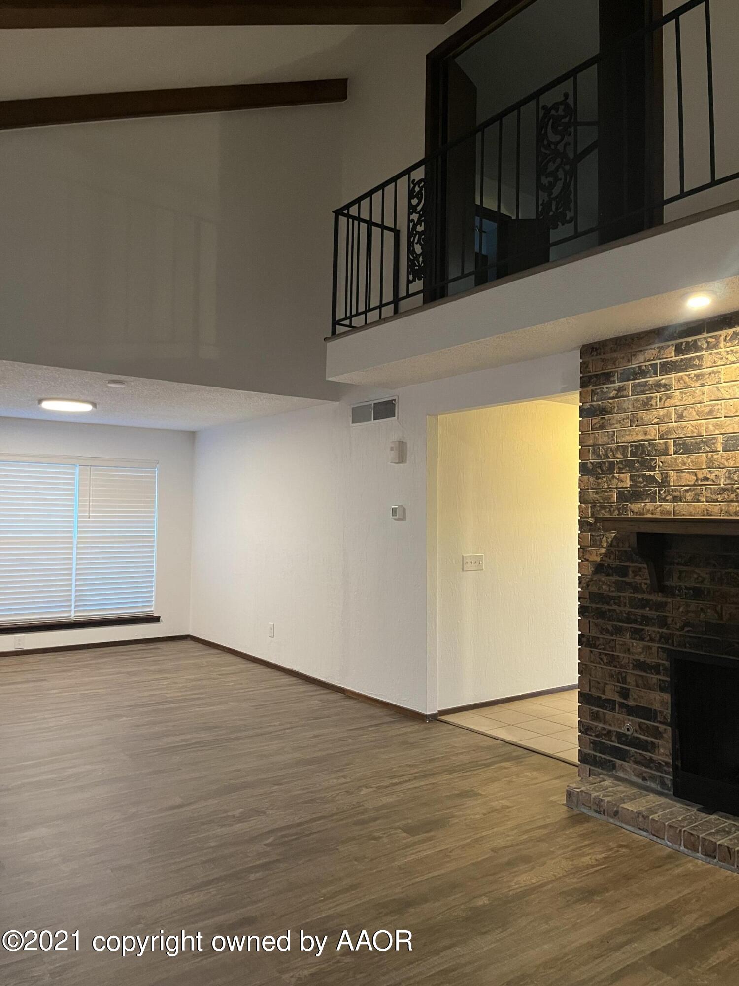 4308 Ridgecrest Circle Amarillo, TX 79109 - Photo 4 of 12 a view of an empty room with wooden floor and a window