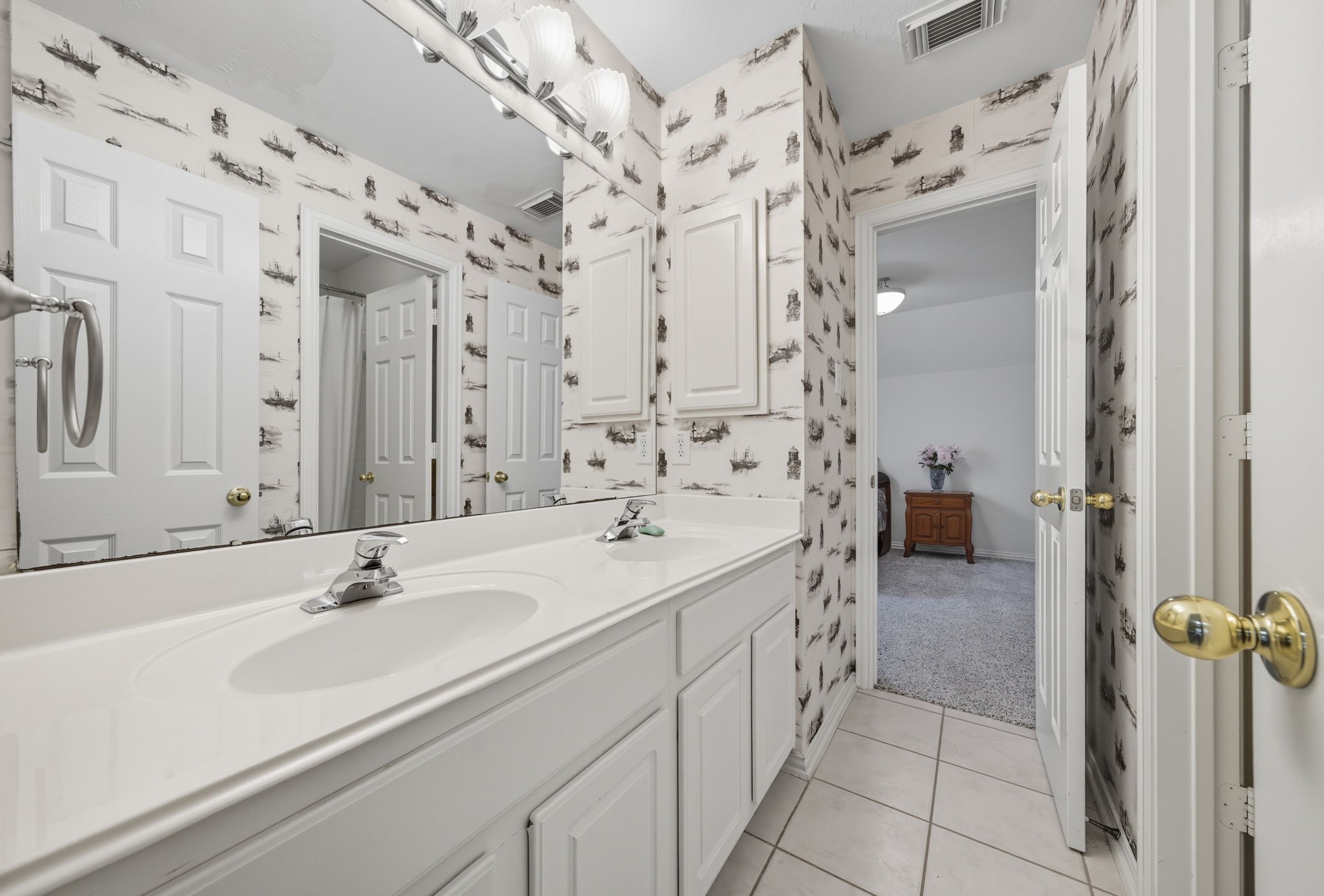 2302 Palm Circle Seabrook, TX 77586 - Photo 25 of 35 a en suite bathroom with a sink a mirror and a shower