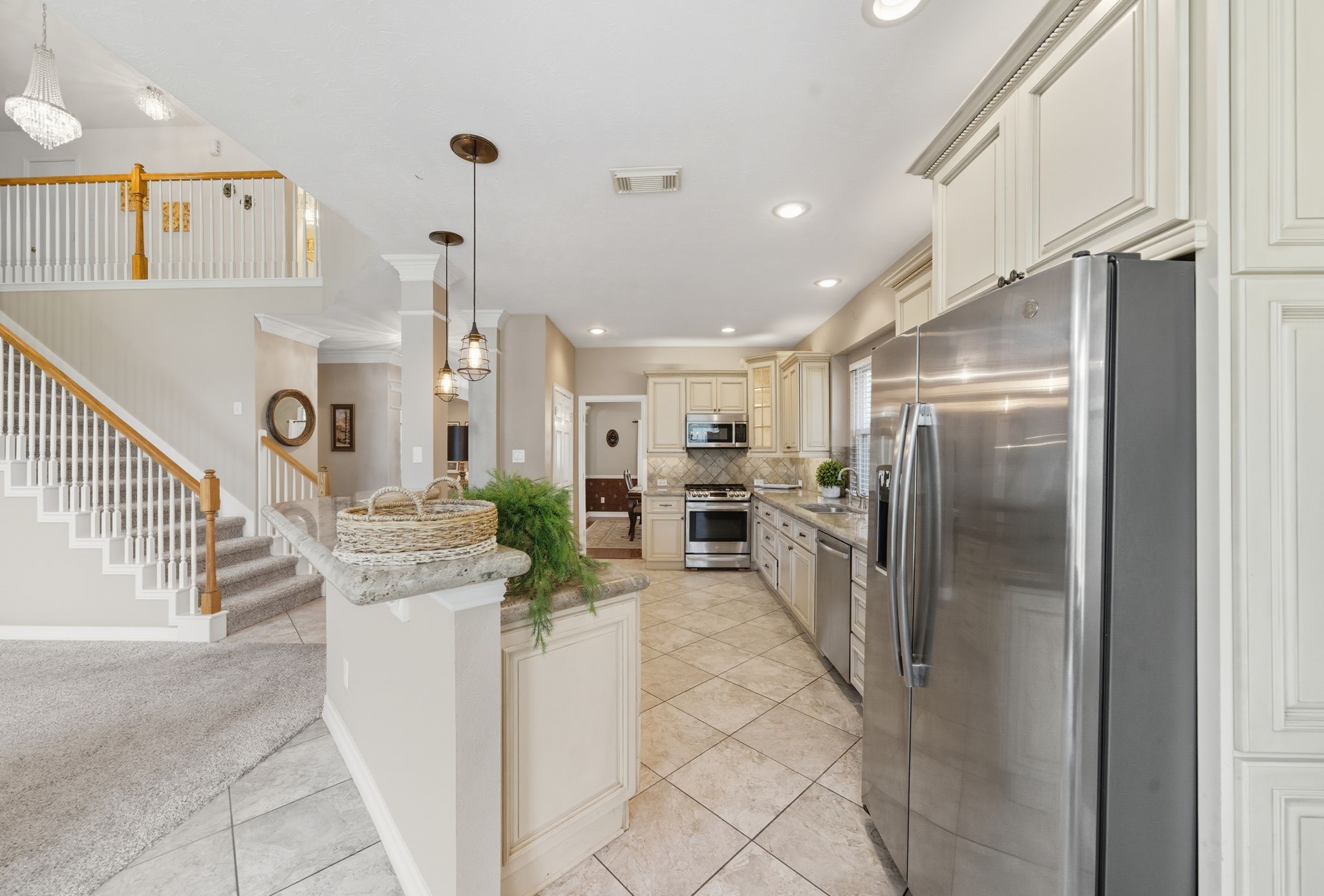 2302 Palm Circle Seabrook, TX 77586 - Photo 10 of 35 a kitchen with stainless steel appliances kitchen island granite countertop a refrigerator and a stove
