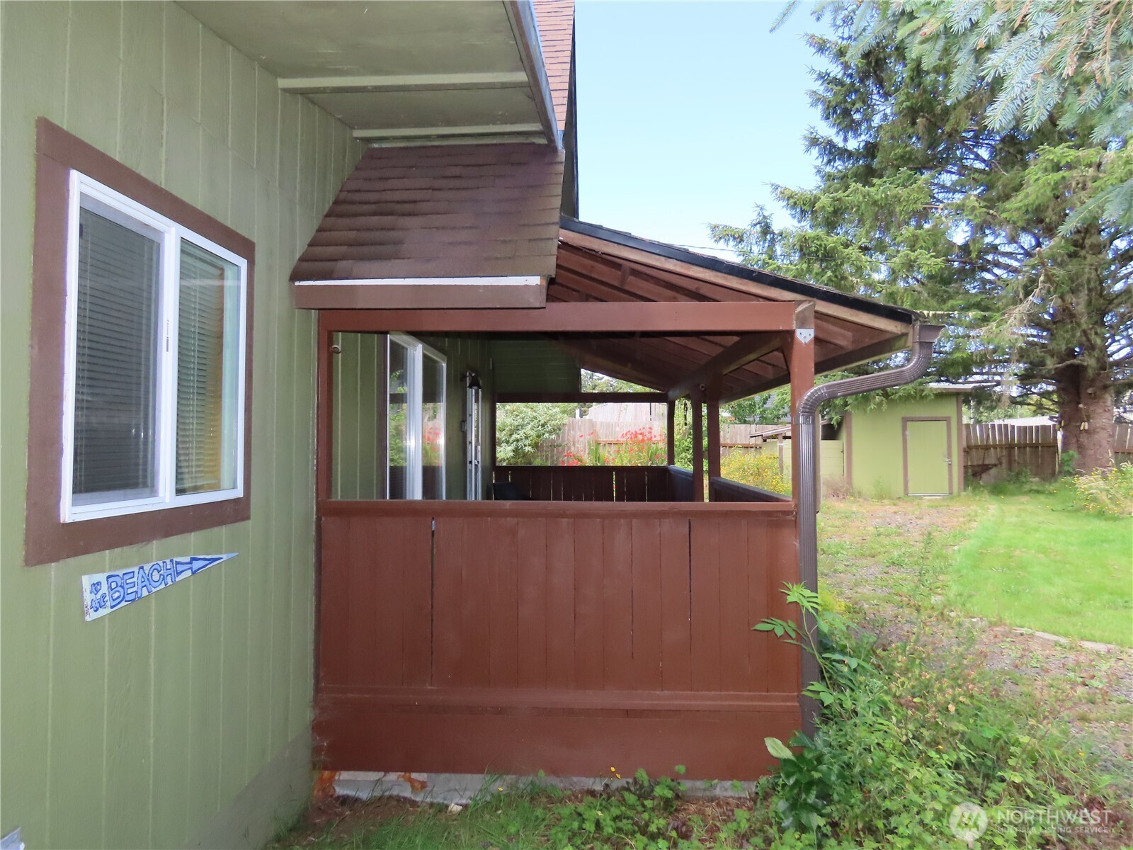 845 Schmid Road Grayland, WA 98547 - Photo 4 of 34 a view of a backyard with table and chairs under an umbrella