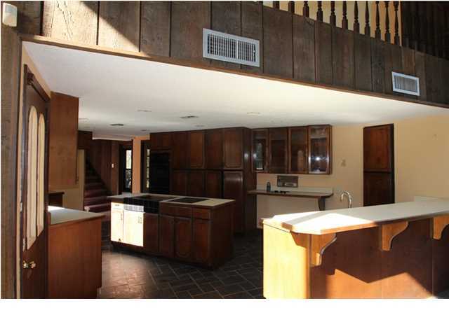 1500 Preservation Path Baker, FL 32531 - Photo 6 of 20 a kitchen with stainless steel appliances kitchen island granite countertop a refrigerator and a stove