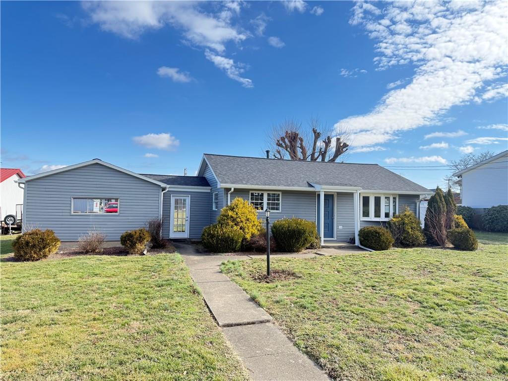 504 Lafayette Street Perryopolis, PA 15473 - Photo 2 of 2 a front view of a house with a yard and garage
