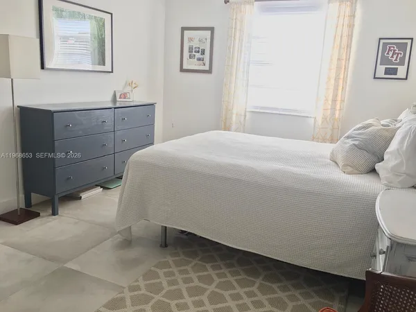 a bedroom with a bed and cabinet