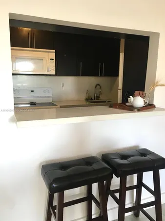 a kitchen with a table and chairs in it