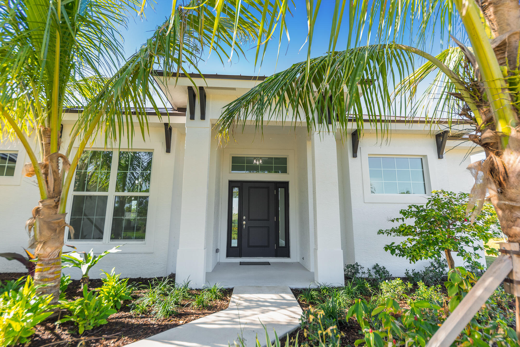 3972 Southeast Fairway West Stuart, FL 34997 - Photo 15 of 52 a front view of a house with a yard