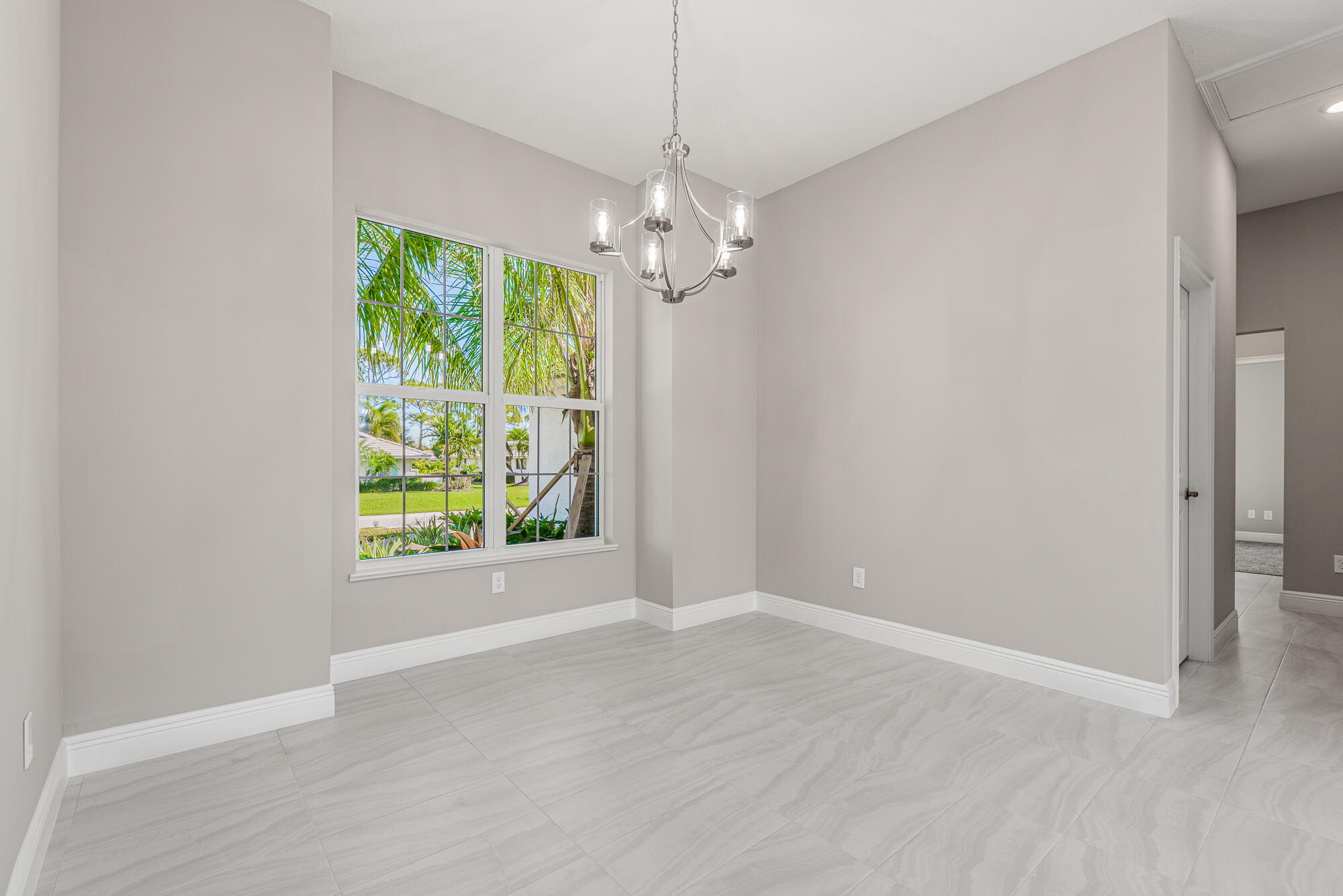 3972 Southeast Fairway West Stuart, FL 34997 - Photo 20 of 52 an empty room with windows and fan