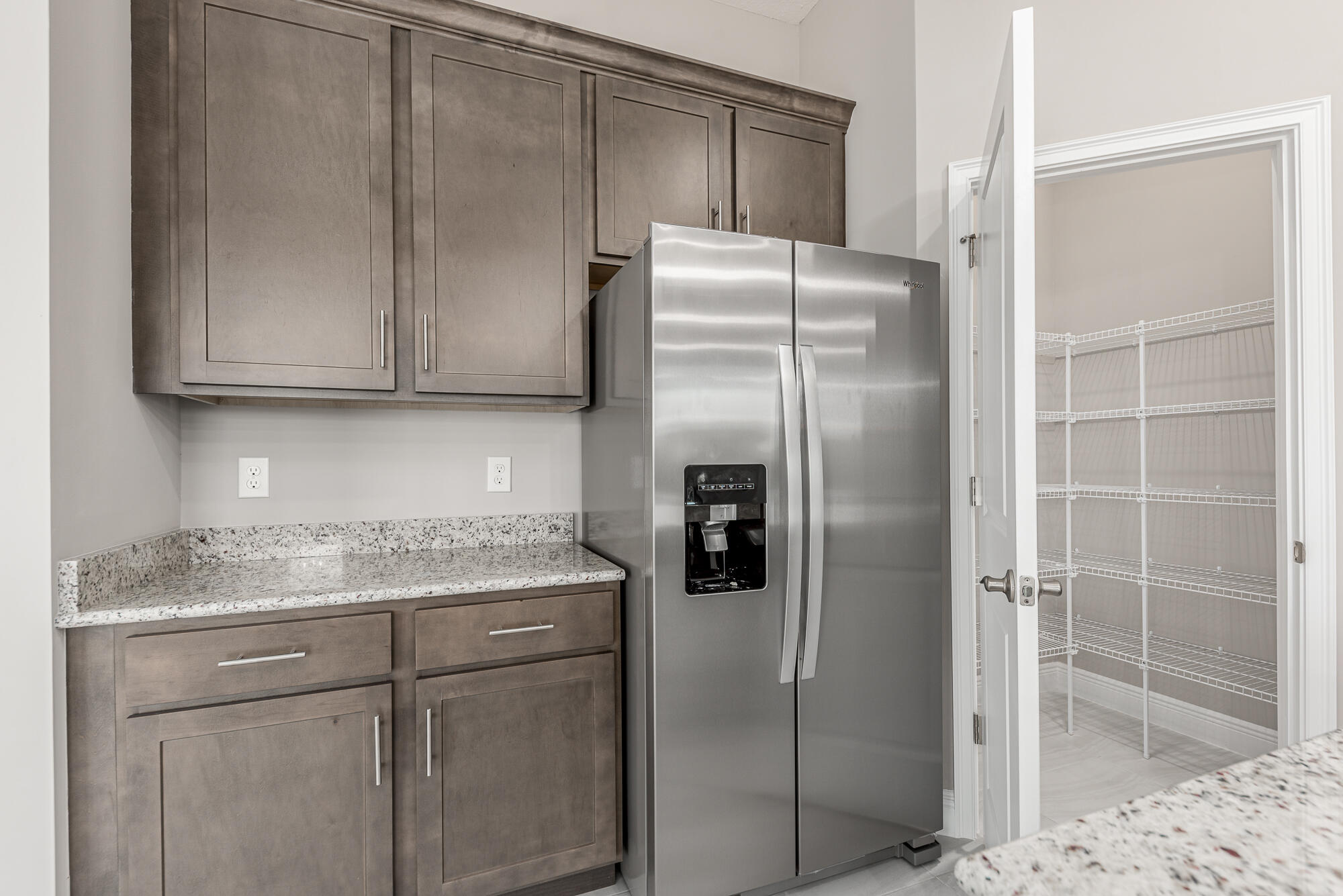 3972 Southeast Fairway West Stuart, FL 34997 - Photo 24 of 52 a kitchen with stainless steel appliances granite countertop a refrigerator and a sink