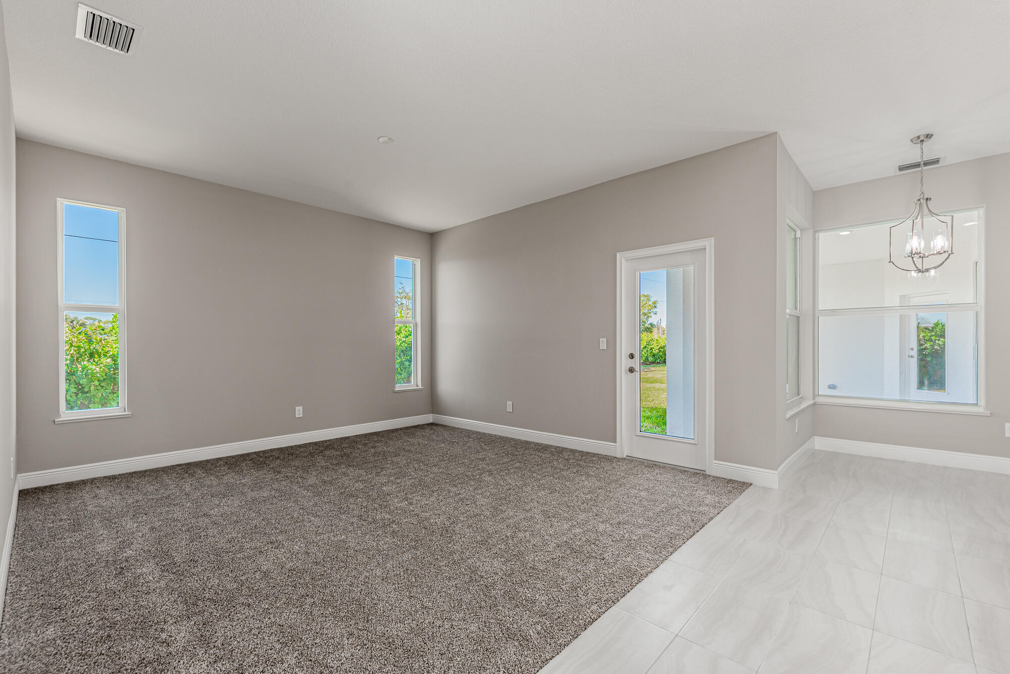 3972 Southeast Fairway West Stuart, FL 34997 - Photo 25 of 52 a view of an empty room with window and wooden floor