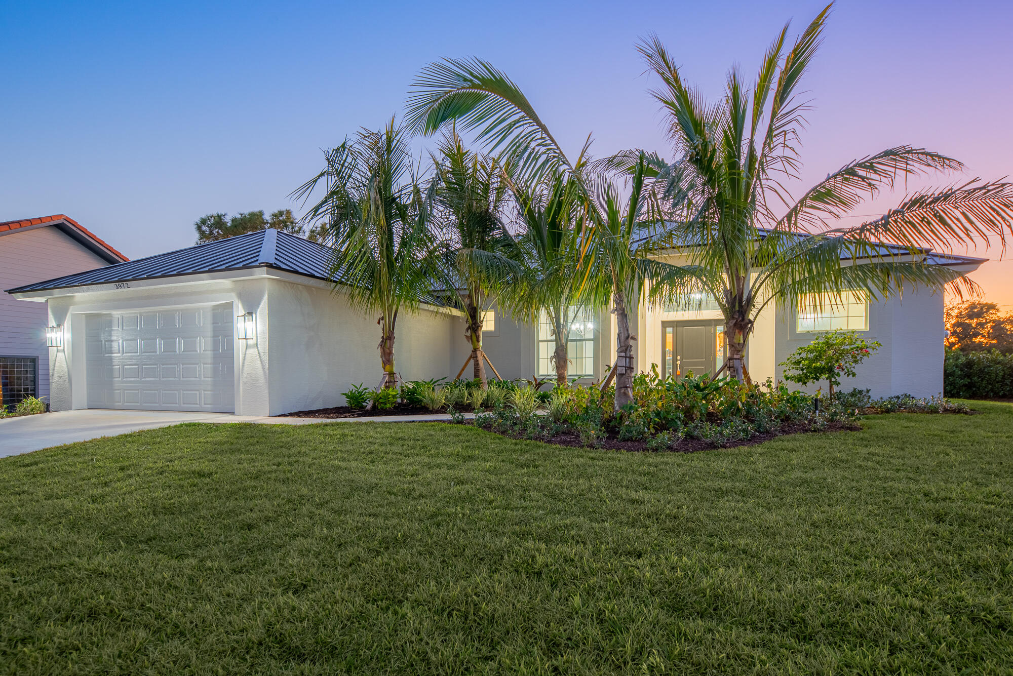 3972 Southeast Fairway West Stuart, FL 34997 - Photo 4 of 52 a front view of a house with a garden