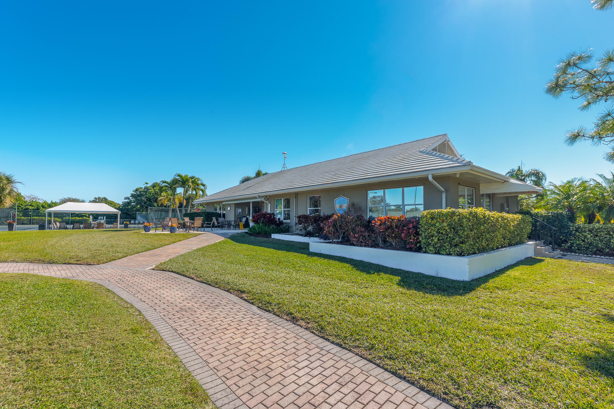 3972 Southeast Fairway West Stuart, FL 34997 - Photo 46 of 52 a front view of a house with garden