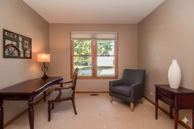 a spacious bedroom with a bed and a dresser