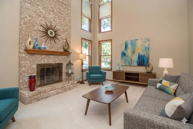 a living room with furniture and a fireplace