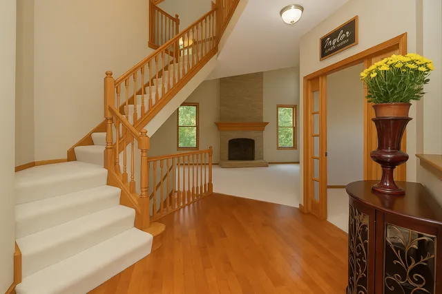 a view of entryway and hall with wooden floor