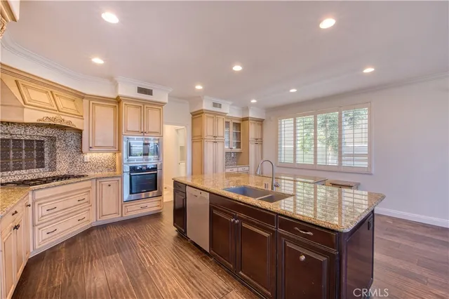 a kitchen with stainless steel appliances granite countertop a sink stove and refrigerator