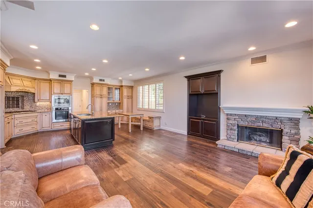 a living room with furniture wooden floor and a fireplace