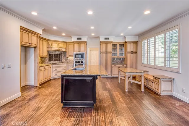 a open kitchen with stainless steel appliances granite countertop a stove and refrigerator