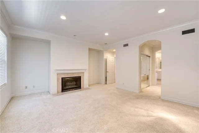 an empty room with a fireplace and window
