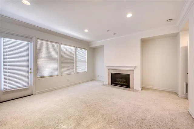 a view of empty room with a fireplace