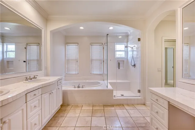 a spacious bathroom with a double vanity sink shower and a bathtub
