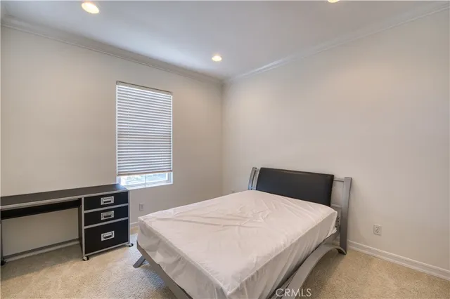 a spacious bedroom with a bed and furniture