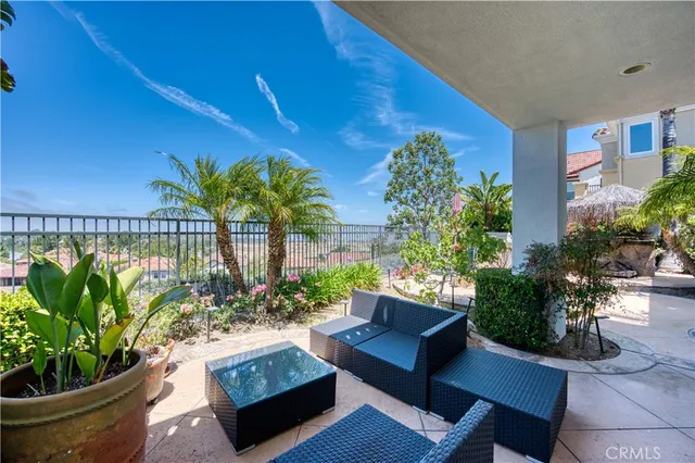 a view of a backyard with plants and swimming pool