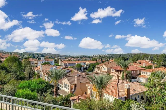 an aerial view of residential houses with outdoor space and street view