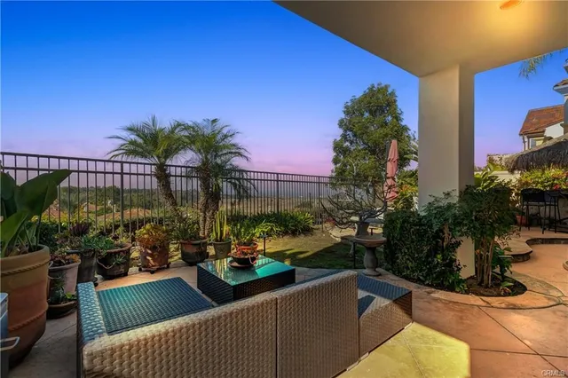 a wooden bench sitting in backside of a house
