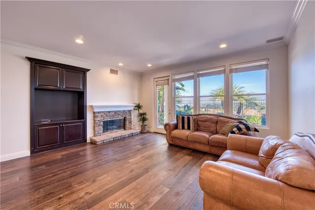 a living room with fireplace furniture and a large window