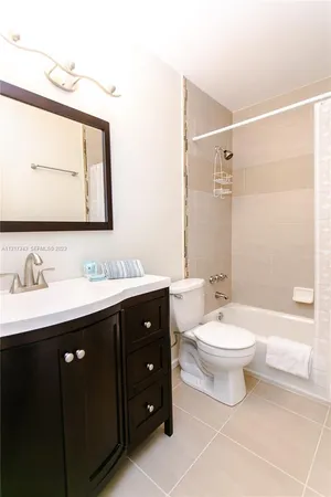 a bathroom with a double vanity sink mirror and toilet