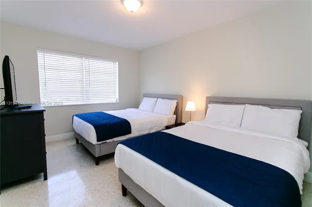 a bedroom with two beds and a couch