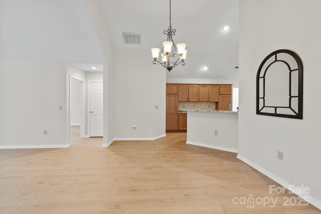 a view of a kitchen with a sink and a chandelier