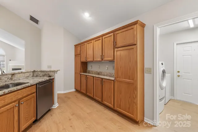a kitchen with stainless steel appliances granite countertop a refrigerator and a sink