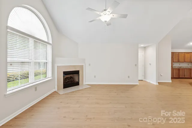 an empty room with a fireplace and a window