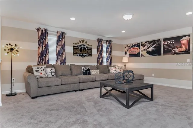 a living room with furniture and wall paintings