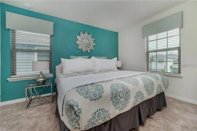 a bed sitting in a bedroom next to a window