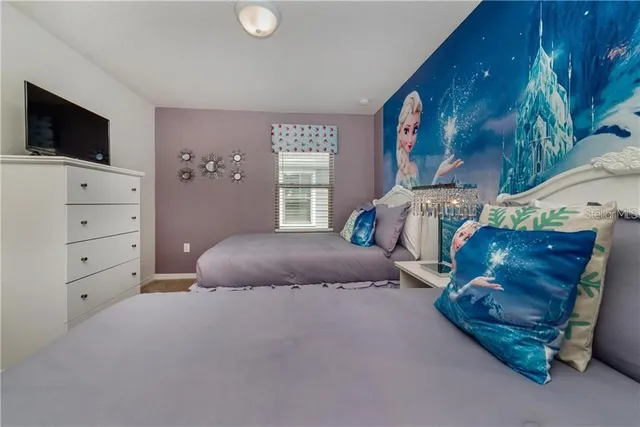 a bedroom with furniture and a flat screen tv