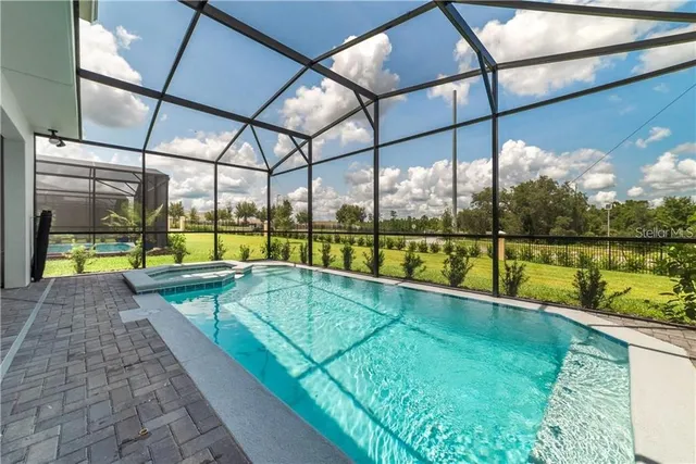 a view of swimming pool with a yard and sitting area