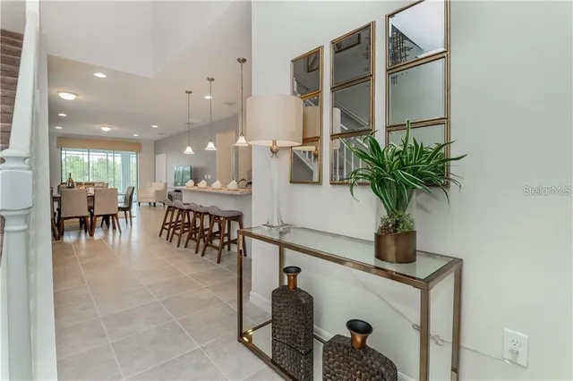 a hallway with a potted plant on a table and a potted plant