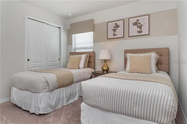 a bedroom with two beds and a window