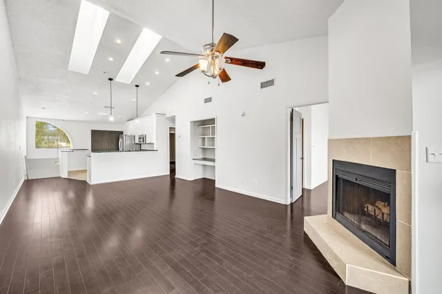 a view of a kitchen with wooden floor and electronic appliances