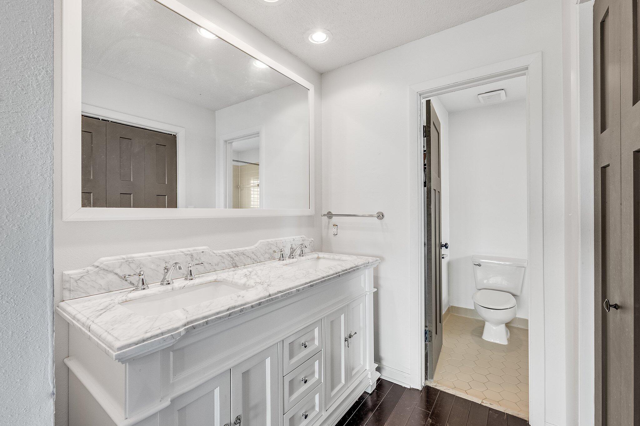 8983 Heron Walk Drive, Unit 8983 Miramar Beach, FL 32550 - Photo 19 of 57 a bathroom with a granite countertop sink and a mirror