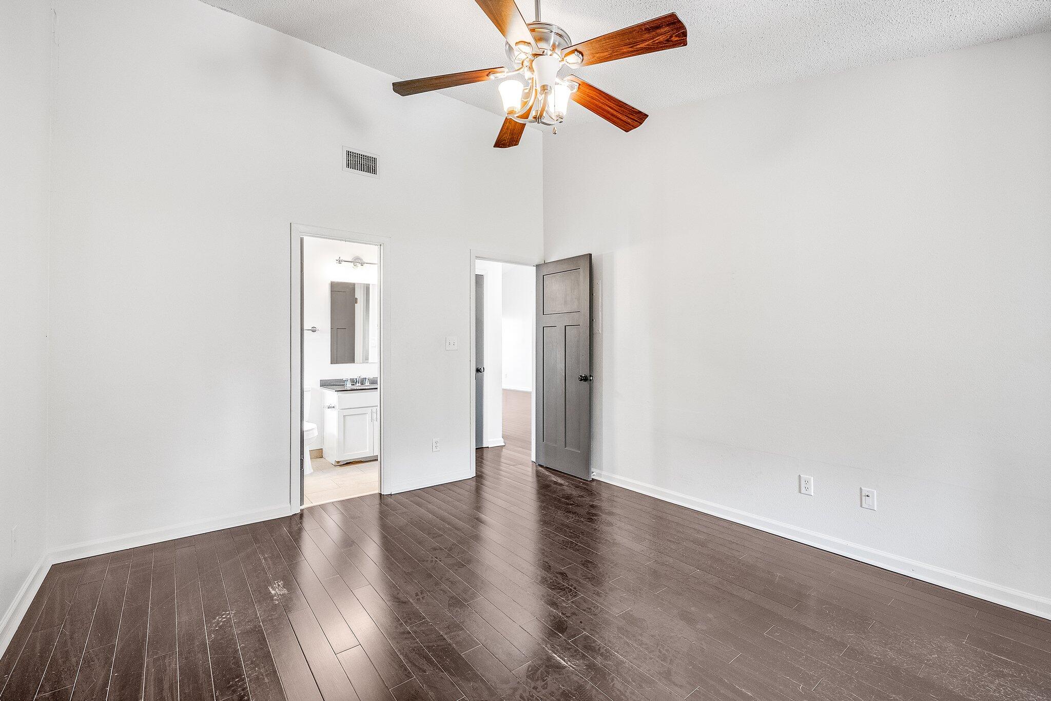 8983 Heron Walk Drive, Unit 8983 Miramar Beach, FL 32550 - Photo 23 of 57 an empty room with wooden floor ceiling fan and window